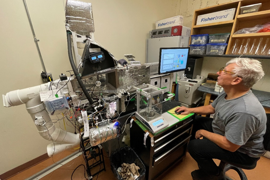 Intern Gary Johnson with apparatus he built at SLC to capture data to demonstrate using brine to remove moisture. Photo supplied by Daniel Liao, Dean, Applied Science, Technology & Trades.